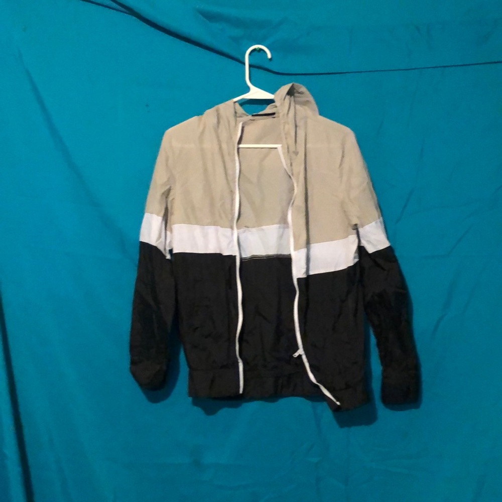 This is a Black, Tan and white windbreaker